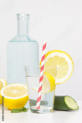 Lemon cucumber water with colorful paper straw. Healthy detox drink.