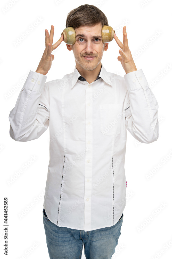 Young handsome tall slim white man with brown hair pressing two tea cups against his forehead in white shirt isolated on white background Young handsome tall slim white man with brown hair pressing two tea cups against his forehead in white shirt isolated on white background