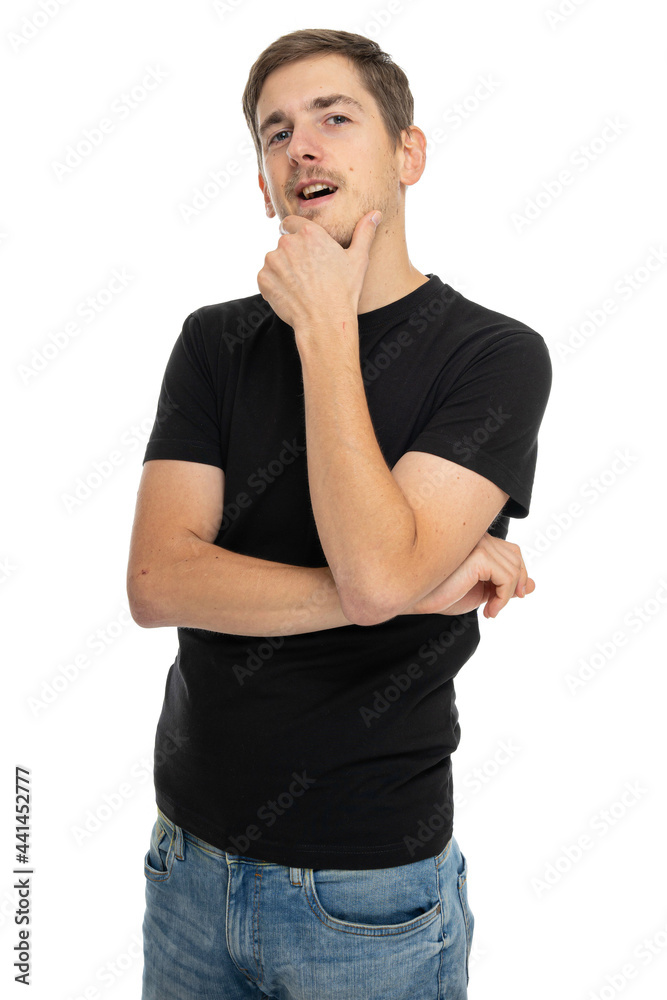 Young handsome tall slim white man with brown hair looks like he has an idea in black shirt isolated on white background
