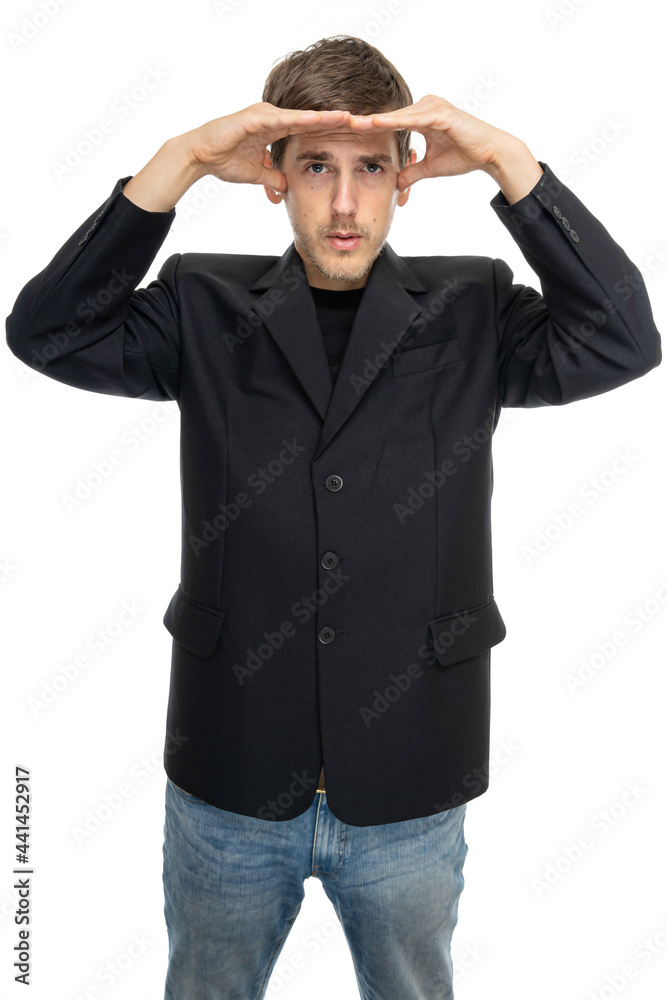 Young handsome tall slim white man with brown hair covers his eyes from sun in black blazer in blue jeans isolated on white background Young handsome tall slim white man with brown hair covers his eyes from sun in black blazer in blue jeans isolated on white background