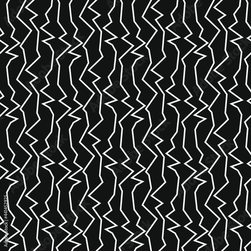 Vertical white zigzags on a black background. Seamless pattern for any use.