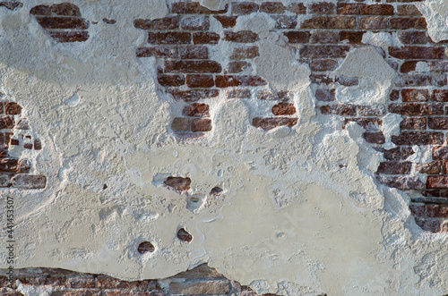 Wall texture with white wall and bricks from a venetian alley