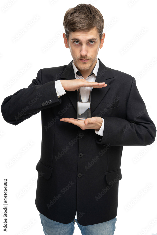 Young handsome tall slim white man with brown hair holding glass of water in black blazer isolated on white background Young handsome tall slim white man with brown hair holding glass of water in black blazer isolated on white background