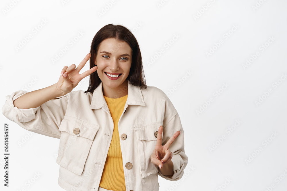 Summer people. Beautiful happy adult woman, showing peace v-signs, smiling white teeth and looking positive at camera, enjoying free leisure time, white background Summer people. Beautiful happy adult woman, showing peace v-signs, smiling white teeth and looking positive at camera, enjoying free leisure time, white background