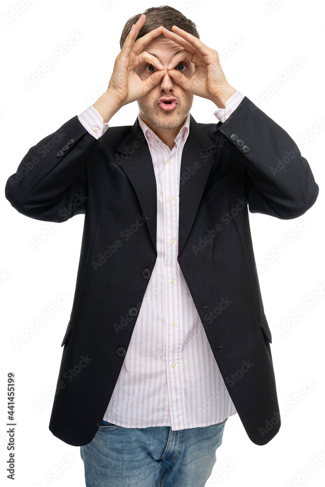 Young handsome tall slim white man with brown hair making glasses with hands in black blazer isolated on white background Young handsome tall slim white man with brown hair making glasses with hands in black blazer isolated on white background