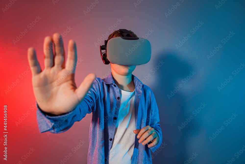 Teenager boy using a gaming gadget for virtual reality Teenager boy using a gaming gadget for virtual reality