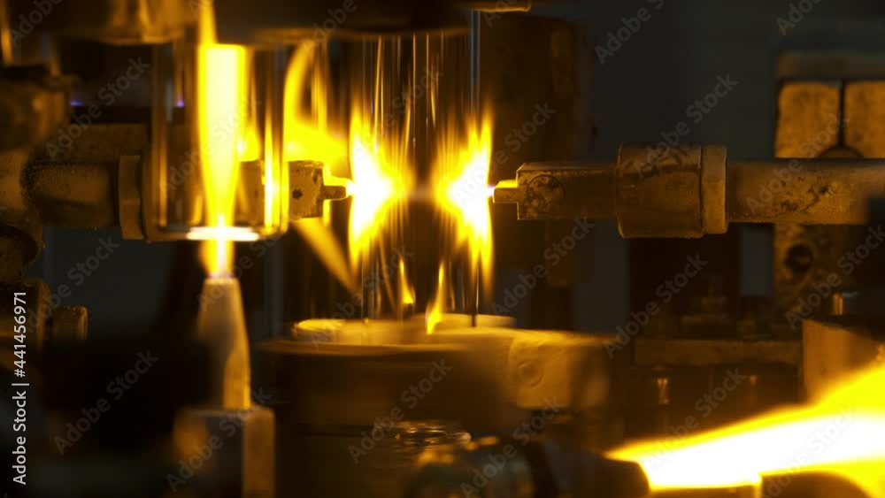 Close-Up Lockdown Shot Of Flames On Glass Jars Manufacturing In Industry - Stuttgart, Germany Close-Up Lockdown Shot Of Flames On Glass Jars Manufacturing In Industry - Stuttgart, Germany