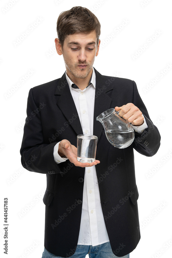 Young handsome tall slim white man with brown hair holding glass pitcher of water and glass of water isolated on white background Young handsome tall slim white man with brown hair holding glass pitcher of water and glass of water isolated on white background