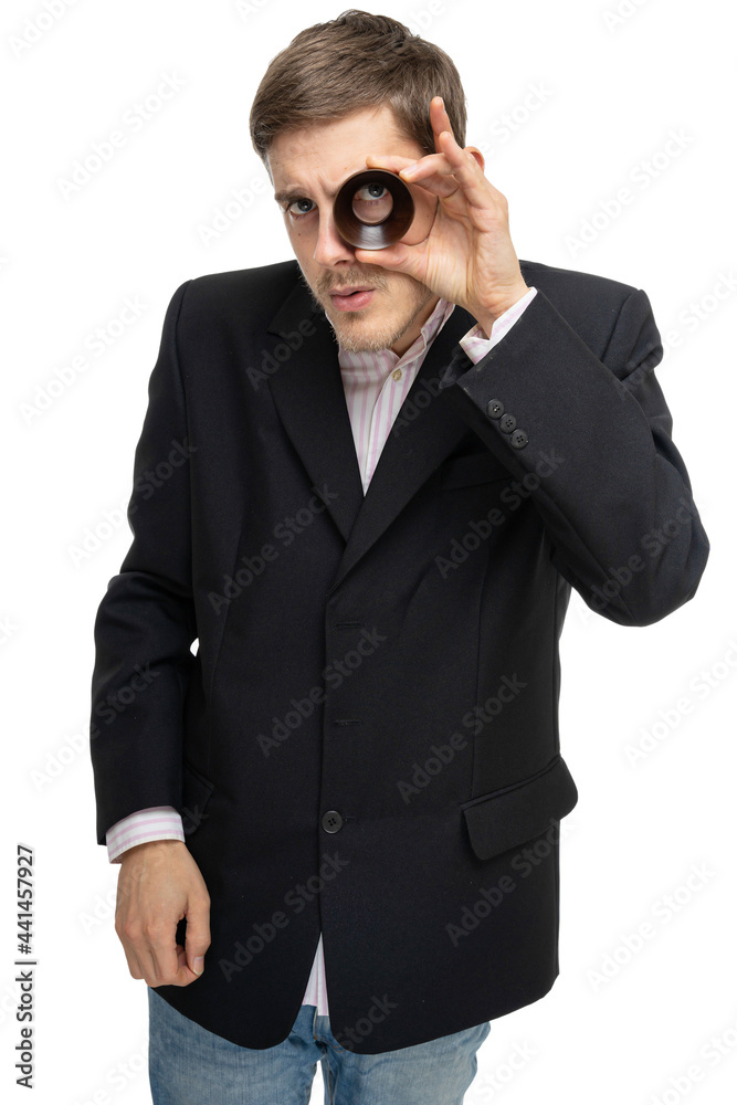 Young handsome tall slim white man with brown hair looking through wooden ring in black blazer isolated on white background Young handsome tall slim white man with brown hair looking through wooden ring in black blazer isolated on white background