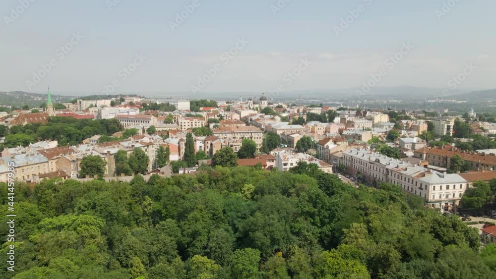Chernivtsi, Ukraine - May 23, 2021: View of architectural structures of the tourist city from a bird's eye view. City park and houses, town hall and distant church, view with quadcopter. Horizon line Chernivtsi, Ukraine - May 23, 2021: View of architectural structures of the tourist city from a bird's eye view. City park and houses, town hall and distant church, view with quadcopter. Horizon line