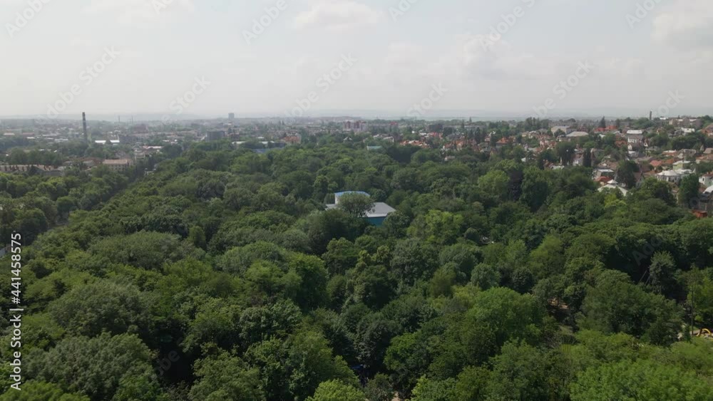 Chernivtsi, Ukraine - May 23, 2021: View of architectural structures of tourist city from bird's eye view. City park and in middle of it house of cultural purpose, view from quadcopter. Horizon line Chernivtsi, Ukraine - May 23, 2021: View of architectural structures of tourist city from bird's eye view. City park and in middle of it house of cultural purpose, view from quadcopter. Horizon line