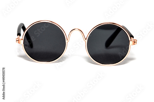 Close-up of round sunglasses on a white background. Gold setting.