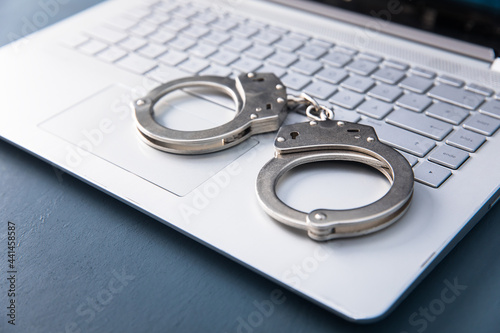 handcuffs on the white computer photo