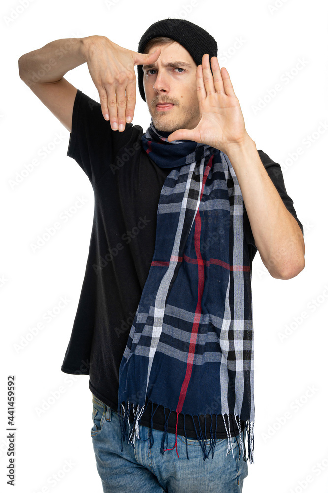 Fototapeta premium Young handsome tall slim white man with brown hair makes frame in front of his face with his hands isolated on white background
