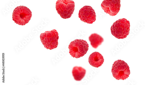Flying raspberries isolated on white background. Sweet ripe fresh delicious raspberry, summer berry, organic food, vitamins. Creative background with falling raspberry fruits
