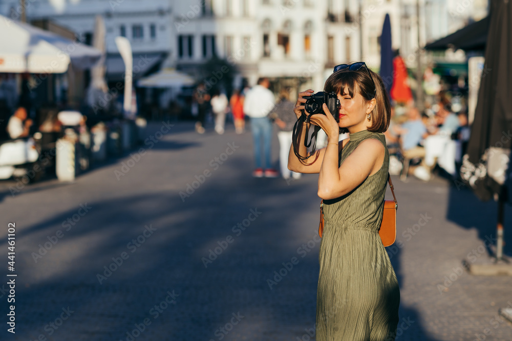 Woman with camera walking in the city Woman with camera walking in the city