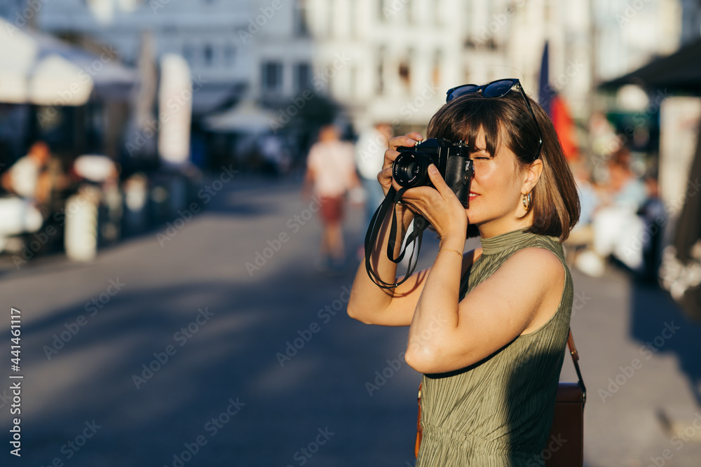 Woman with camera walking in the city