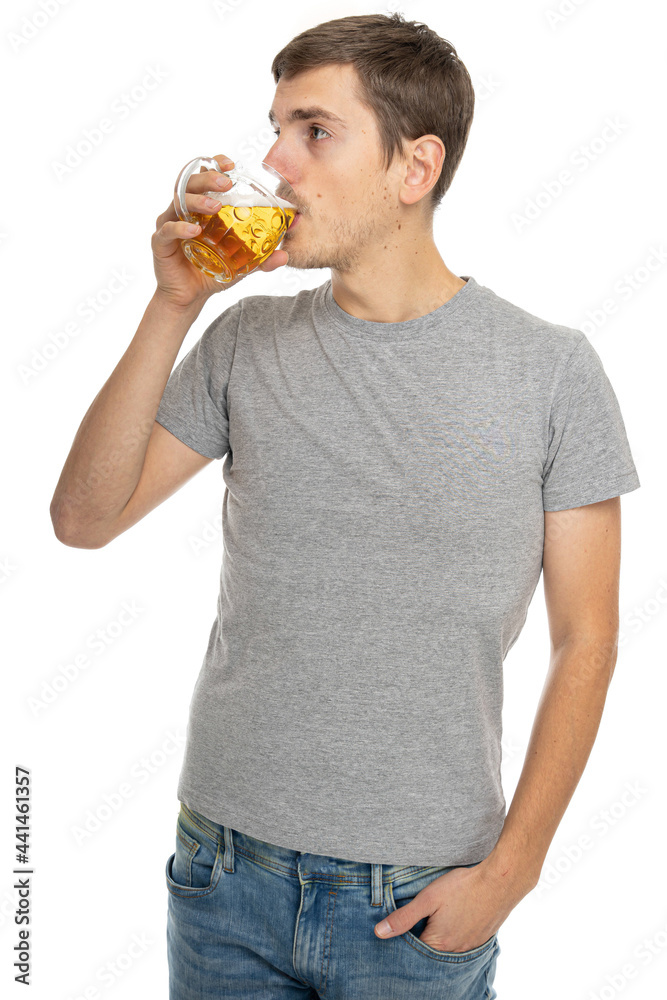 Young handsome tall slim white man with brown hair in gray shirt in blue jeans with glass of beer isolated on white background