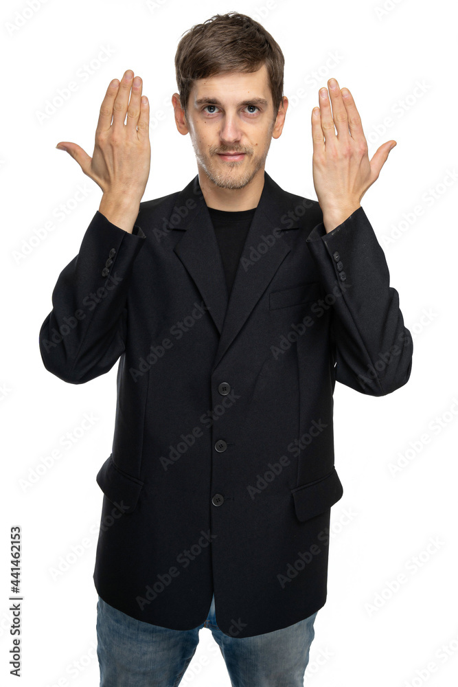 Young handsome tall slim white man with brown hair shows his hands in black blazer in blue jeans isolated on white background Young handsome tall slim white man with brown hair shows his hands in black blazer in blue jeans isolated on white background