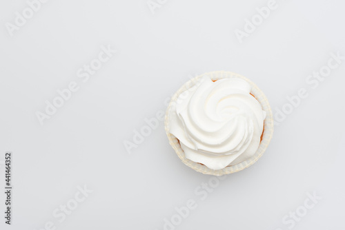 top view of sweet cupcake with icing on top isolated on white