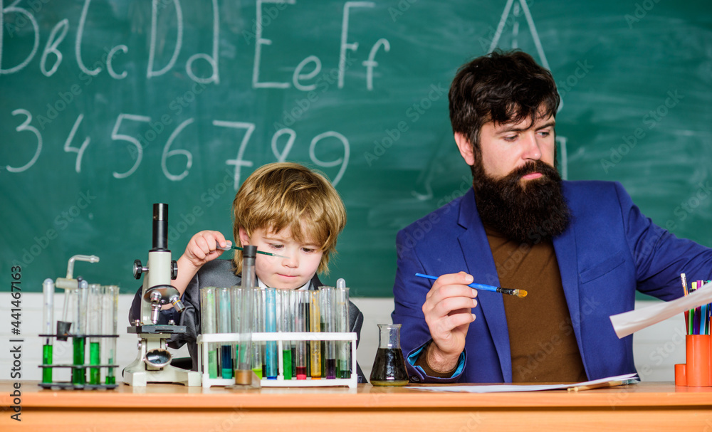 Flask in scientist hand with Test tubes. son and father at school. training room with blackboard. small boy with teacher man. Wisdom. Back to school. A physical chemist can study anything in science Flask in scientist hand with Test tubes. son and father at school. training room with blackboard. small boy with teacher man. Wisdom. Back to school. A physical chemist can study anything in science