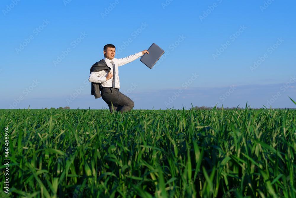 businessman works in a green field, freelance and business concept, green grass and blue sky as background businessman works in a green field, freelance and business concept, green grass and blue sky as background