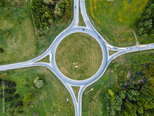 Top down aerial drone view of a small traffic roundabout on a quiet road photo