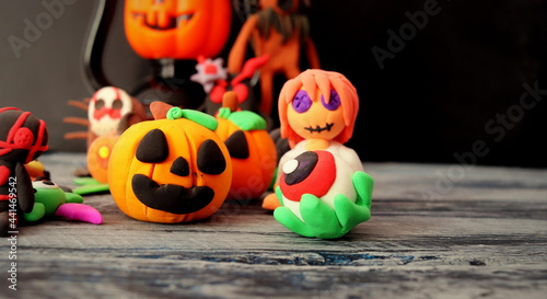 Halloween theme, plasticine figures close-up on a dark background selective focus.