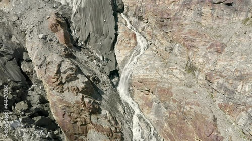 Wallpaper Mural Long slow aerial descent along waterfall surrounded by rocks at Fee glacier near Saas-Fee in Switzerland Torontodigital.ca