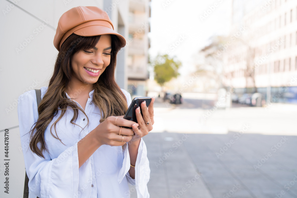 Fototapeta premium Young woman using her mobile phone.
