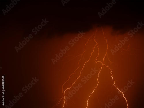 A few lightning bolts on the red background of the sky. The concept of a fantastic thunderstorm on Mars.