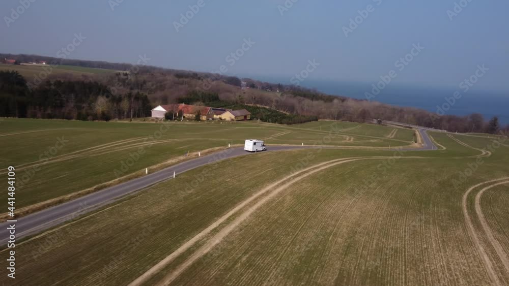 Aerial Shot of White Vehicle Following a Path With the View of the Majestic Sky Aerial Shot of White Vehicle Following a Path With the View of the Majestic Sky