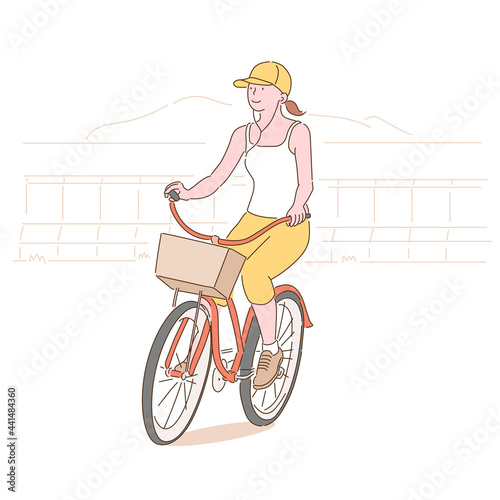 A woman in a hat and earphones is riding a bicycle. hand drawn style vector design illustrations. 
