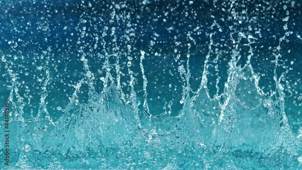 Super slow motion of splashing water isolated on blue background. Filmed on high speed cinema camera, 1000 fps. Super slow motion of splashing water isolated on blue background. Filmed on high speed cinema camera, 1000 fps.