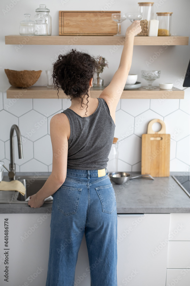 Comfortable white gray kitchen interior open box full of various crockery porcelain or glass plates