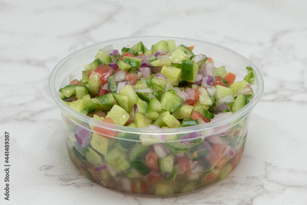 Mediterranean cuisine prepared for a meal in the form of a delicious chopped vegetable salad drizzled with olive oil.
Mediterranean cuisine prepared for a meal in the form of a delicious chopped vegetable salad drizzled with olive oil.