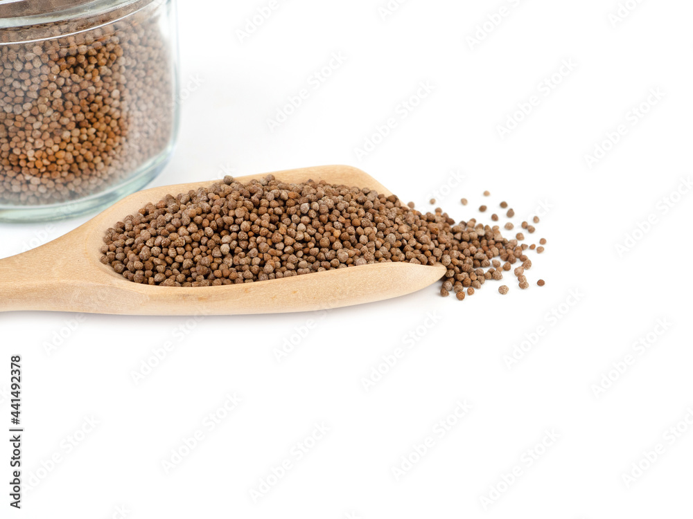 Close up, Perilla seed in wooden spoon with glass bottle isolated on a white background. Healthy food. . Close up, Perilla seed in wooden spoon with glass bottle isolated on a white background. Healthy food. .