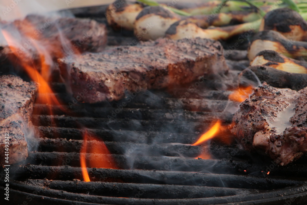 grilling some steak on the grill