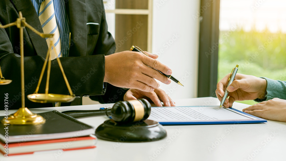 Lawyer Discussing Contract Documents Sitting At A Desk At The Office lawyer-discussing-contract-documents-sitting-at-a-desk-at-the-office