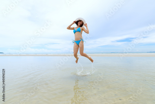 Beautiful woman in a swimsuit enjoying on a beach at summer. Concept for holiday, vacation, relaxing and freedom .Travel and lifestyle Concept happy