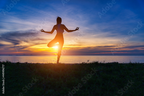 Silhouette healthy woman lifestyle exercising vital meditate and practicing yoga . Healthy Concept.