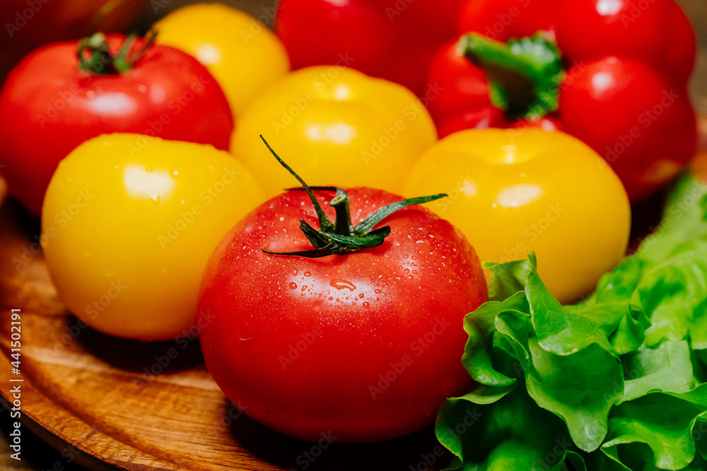 close up. yellow and red tomatoes and bell pepper with water drops. close up. yellow and red tomatoes and bell pepper with water drops.