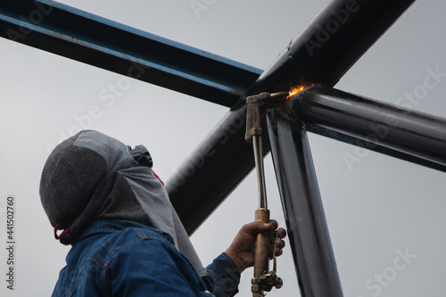 welder use metal weld machine work in a factory