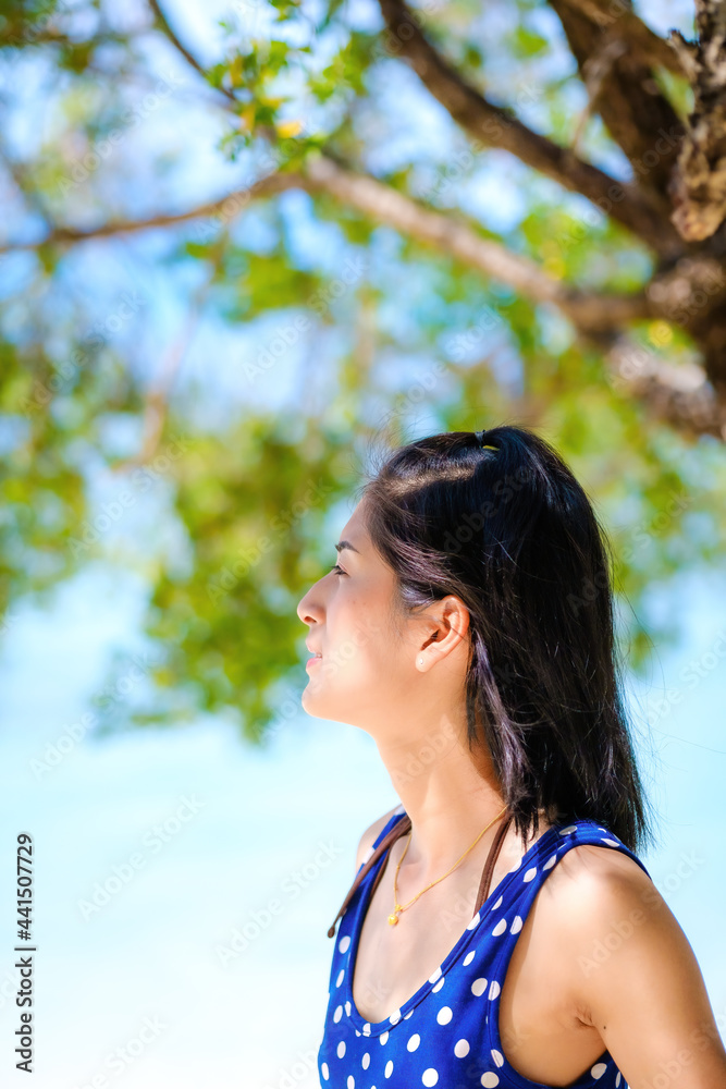 woman in blue dress on the beach, at leela beach koh phangan ,suratthani,thailand woman in blue dress on the beach, at leela beach koh phangan ,suratthani,thailand
