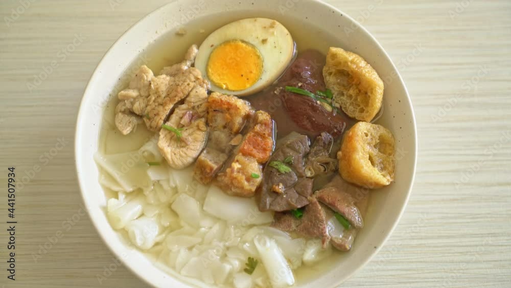 paste of rice flour or boiled Chinese pasta square with pork in clear soup paste of rice flour or boiled Chinese pasta square with pork in clear soup