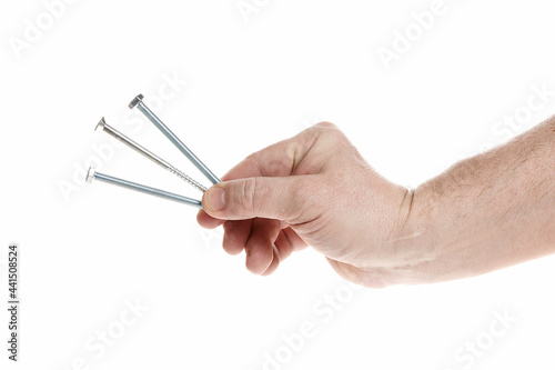 Hand holds metal screws on a white background, a template for designers.