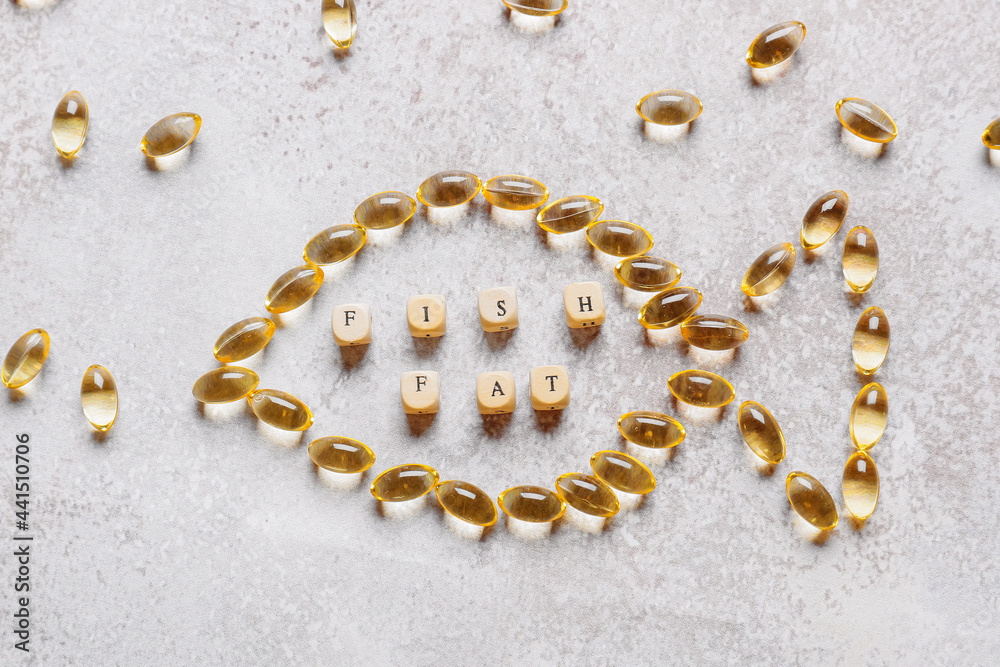 Composition with fish oil pills on grunge background Composition with fish oil pills on grunge background