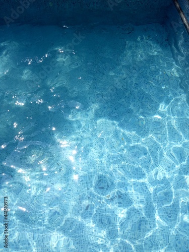 Fototapeta Naklejka Na Ścianę i Meble -  Summer sun reflection at swimming pool