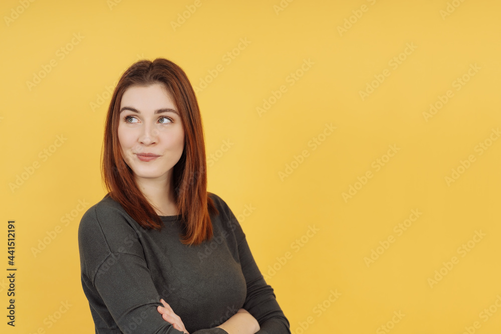 Dubious young woman standing deep in thought
