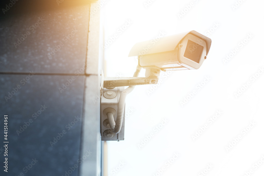 CCTV camera on the wall of an elite house. residential complex security concept CCTV camera on the wall of an elite house. residential complex security concept